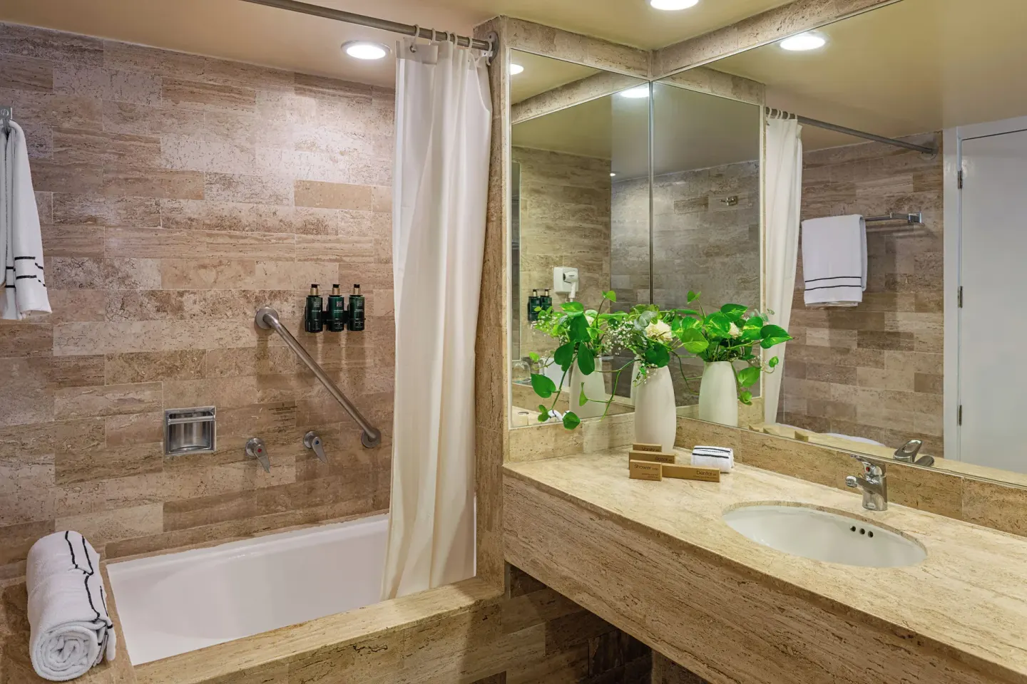 Deluxe Room Sea View bathroom with tub, vanity and mirror at Melia Puerto Vallarta.