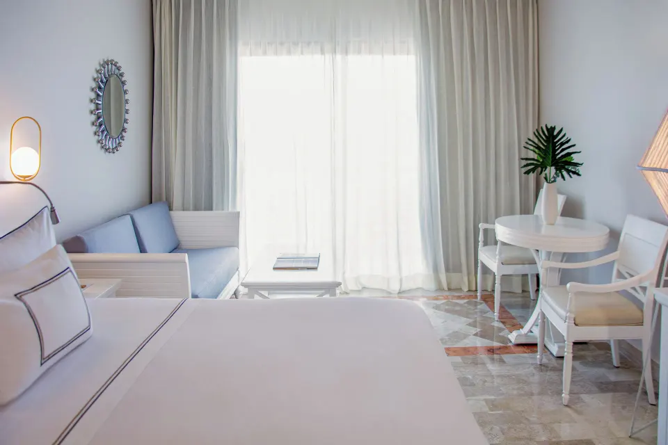 Deluxe Room Sea View king bed, sofa and dining table at Melia Puerto Vallarta.