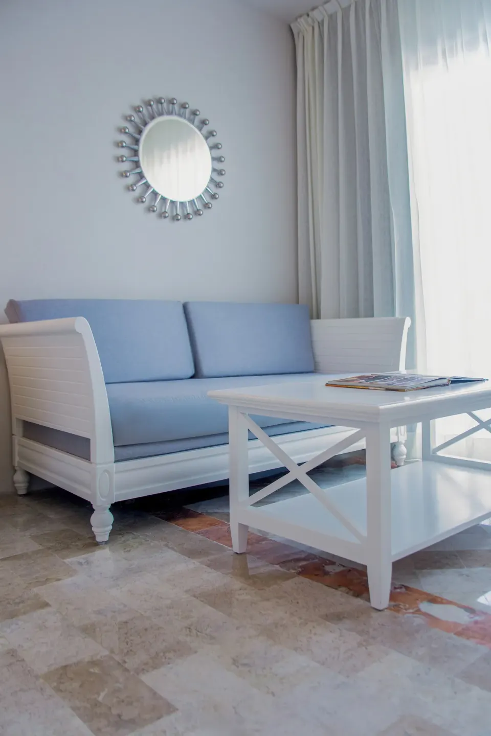 Deluxe Room Sea View seating area with blue sofa and white table at Melia Puerto Vallarta.