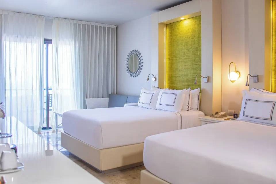 Deluxe Room Sea View with two beds and balcony curtains at Melia Puerto Vallarta.