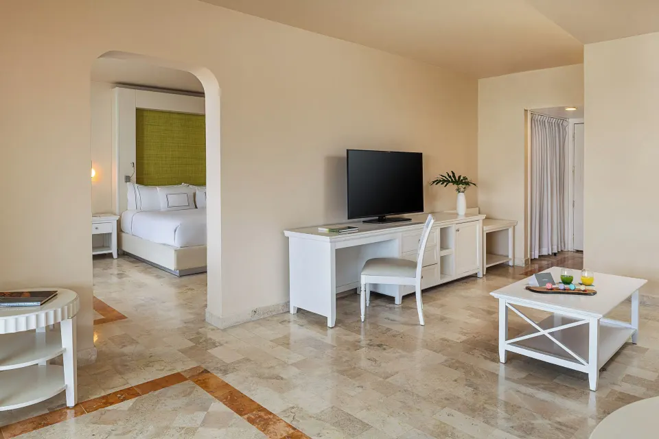 Junior Suite Ocean View living room with desk and bedroom alcove at Melia Puerto Vallarta.