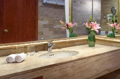 Premium One-Bedroom Suite bathroom vanity with flowers at Melia Puerto Vallarta.