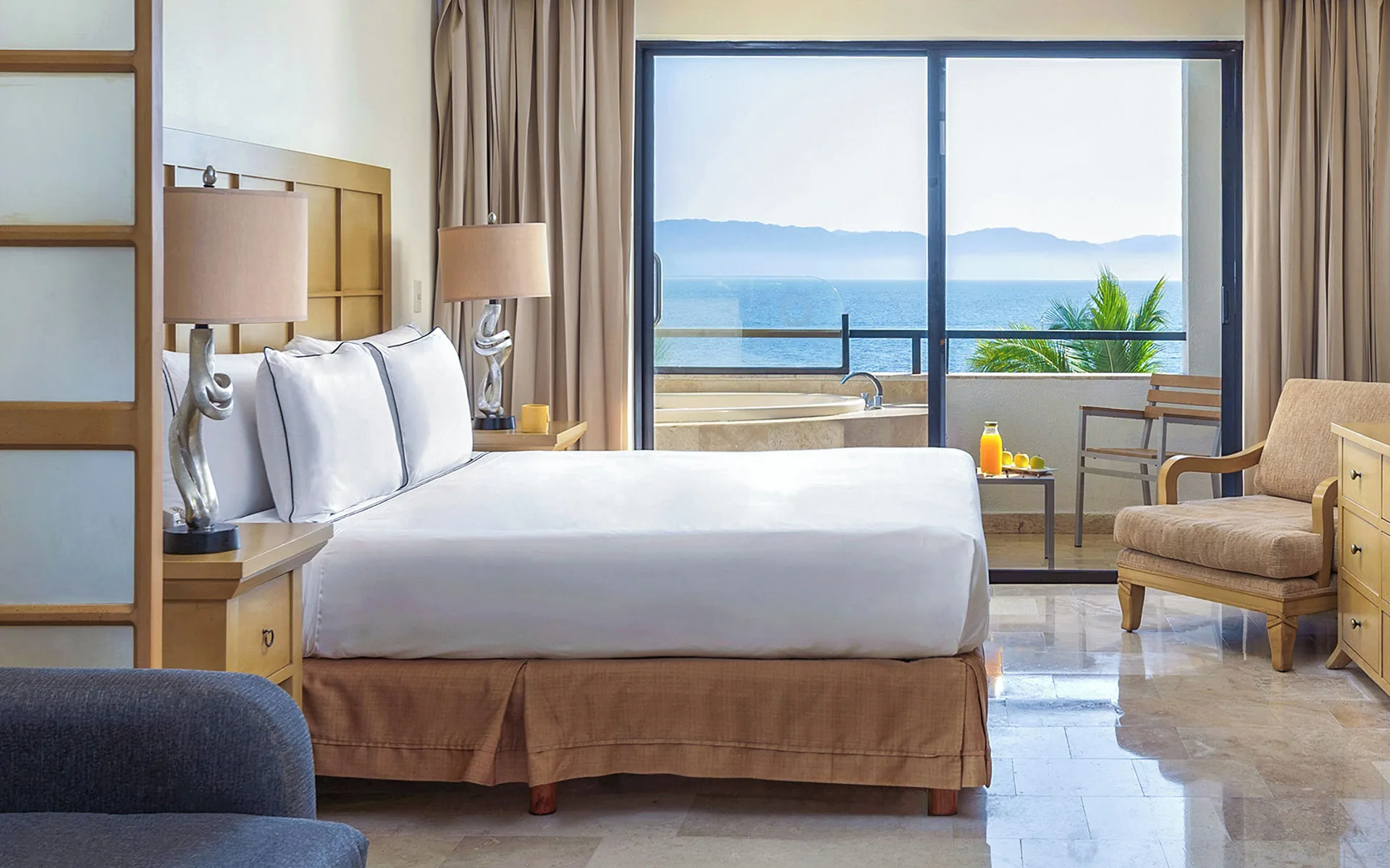Premium Suite bedroom with king bed and ocean-facing balcony at Melia Puerto Vallarta.