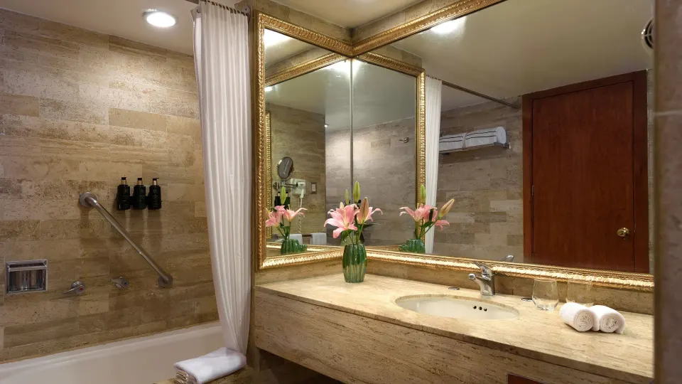 Premium Suite Garden View bathroom with tub, vanity, and mirror at Melia Puerto Vallarta.