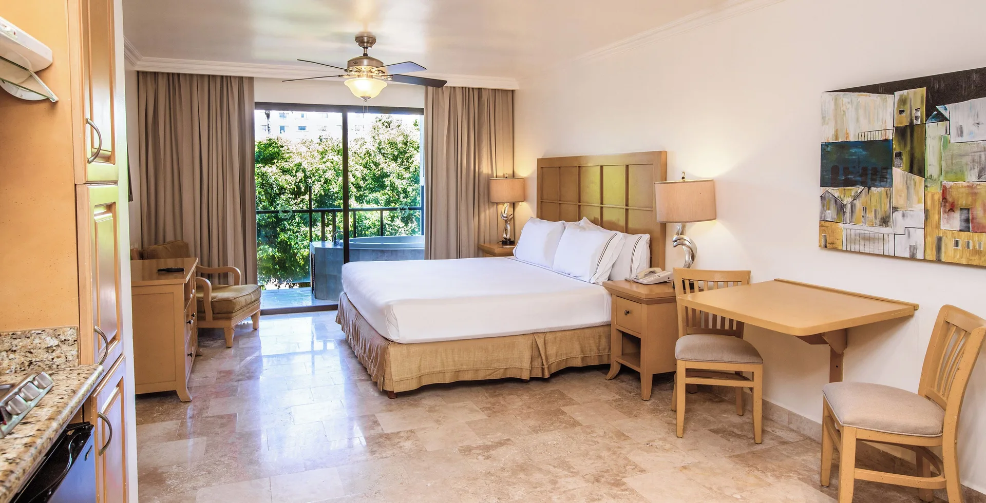 Premium One Bedroom Master Suite Garden View at Melia Puerto Vallarta with king bed, private balcony, and kitchenette overlooking tropical gardens.