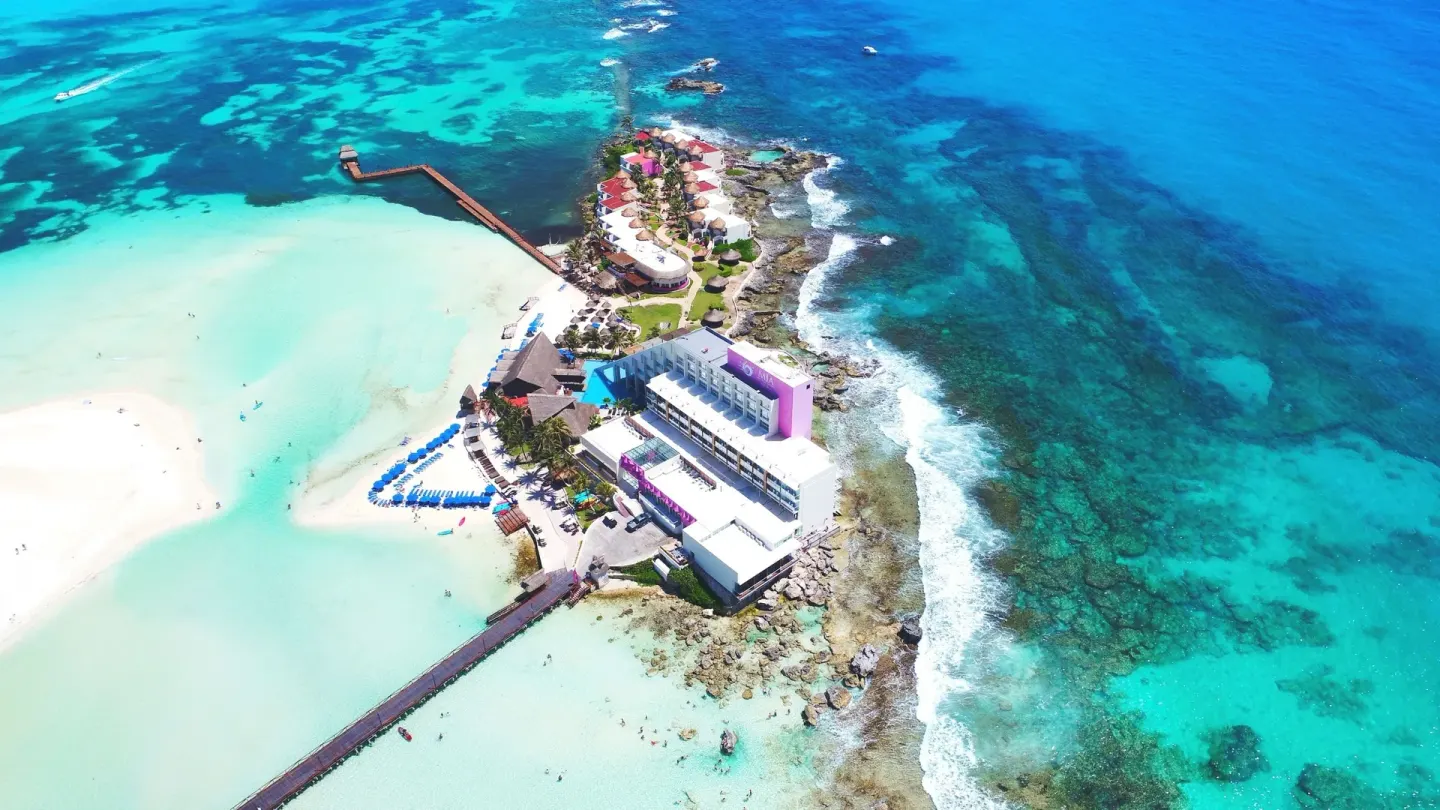 Aerial view of the island resort, beaches, and reef at Mia Reef Isla Mujeres.