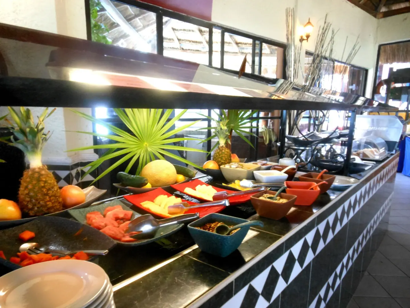 Breakfast buffet with fruit and condiments at Mia Reef Isla Mujeres.