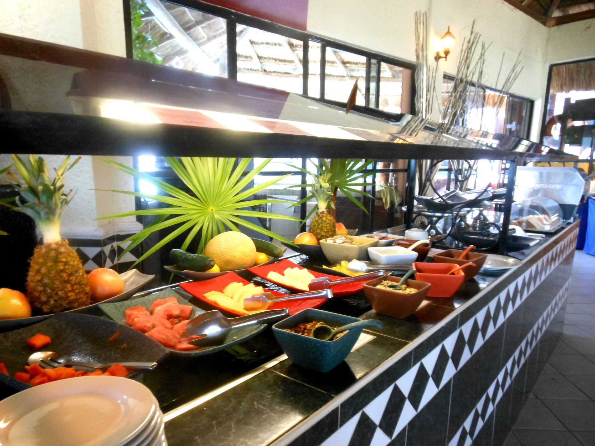 Breakfast buffet with fruit and condiments at Mia Reef Isla Mujeres.