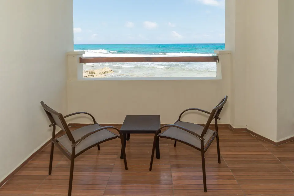 Oceanfront balcony seating for a Deluxe Villa suite at Mia Reef Isla Mujeres.