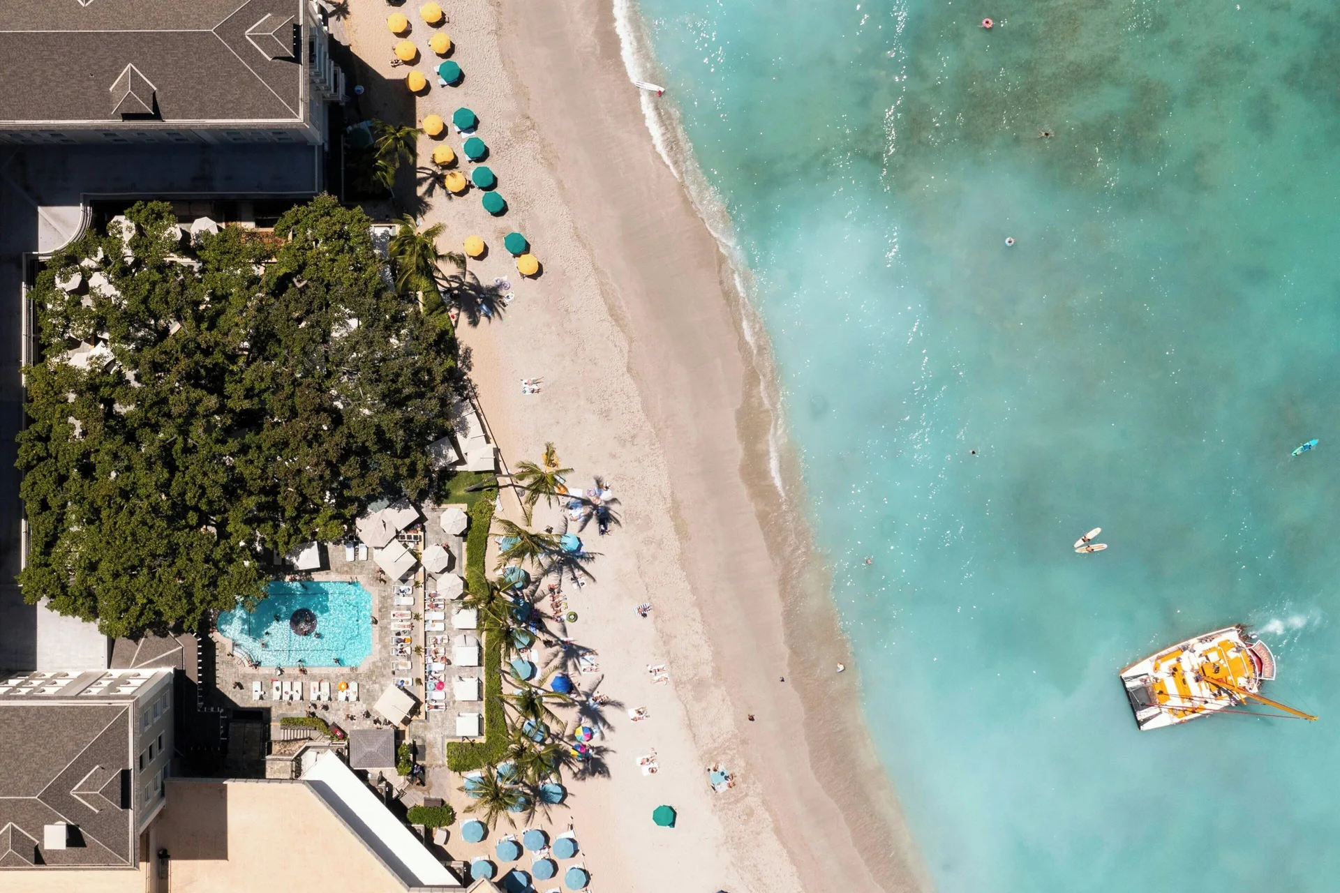 Aerial view of the beach, pool and shoreline at Moana Surfrider, A Westin Resort & Spa.
