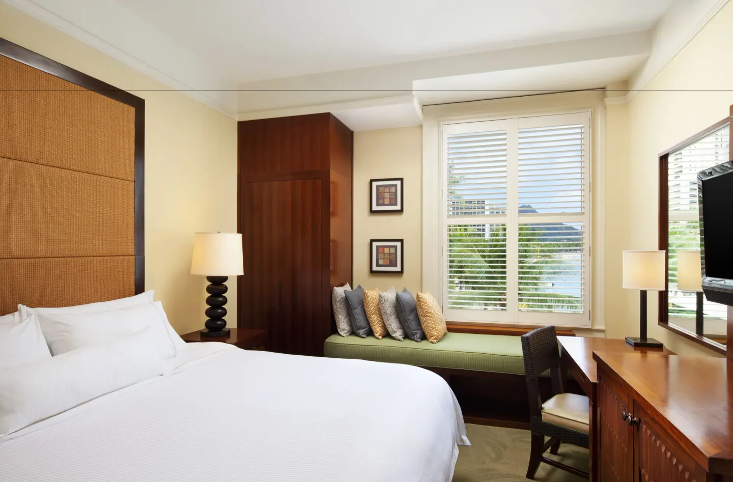 King guest room with desk and window bench at Moana Surfrider, A Westin Resort & Spa.