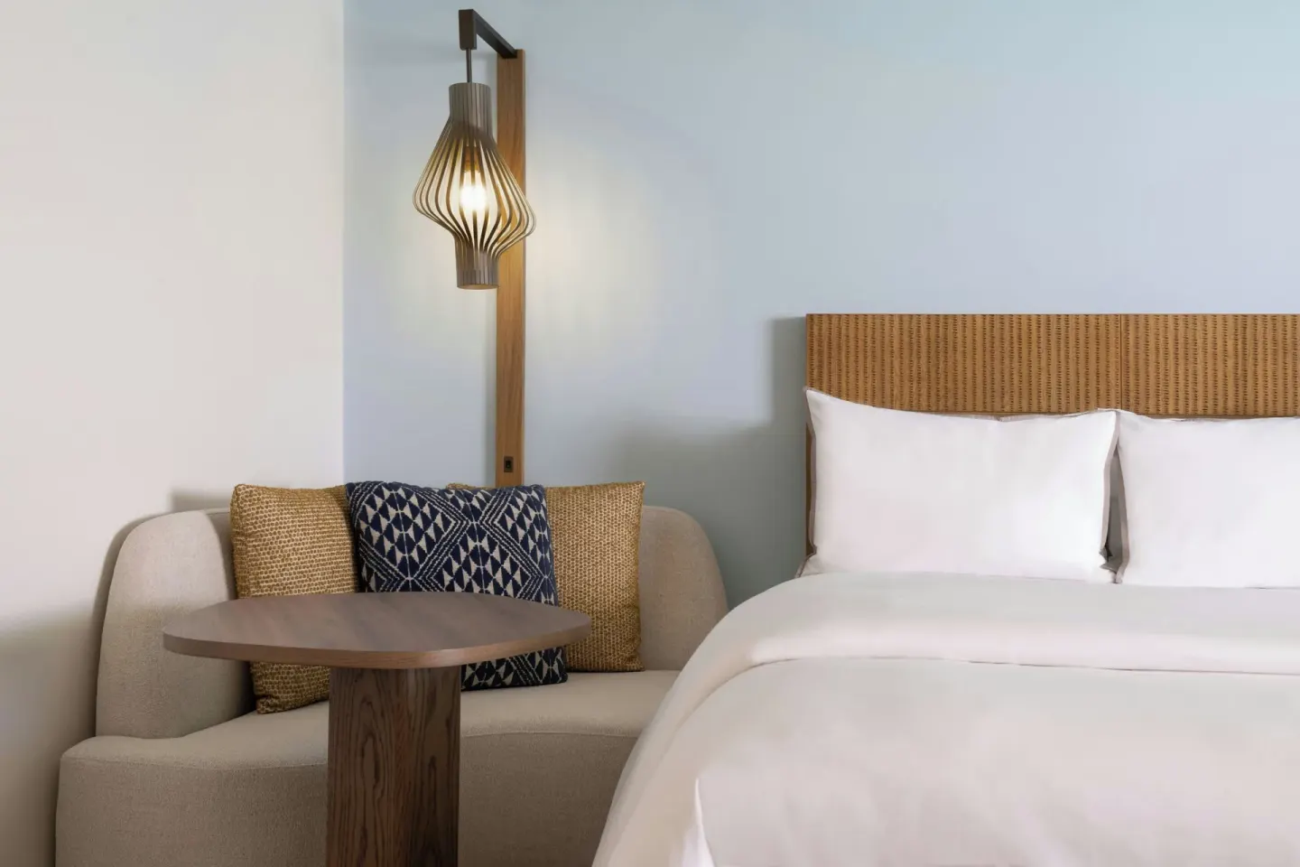 King bed and sofa nook in a guest room at Moana Surfrider, A Westin Resort & Spa.