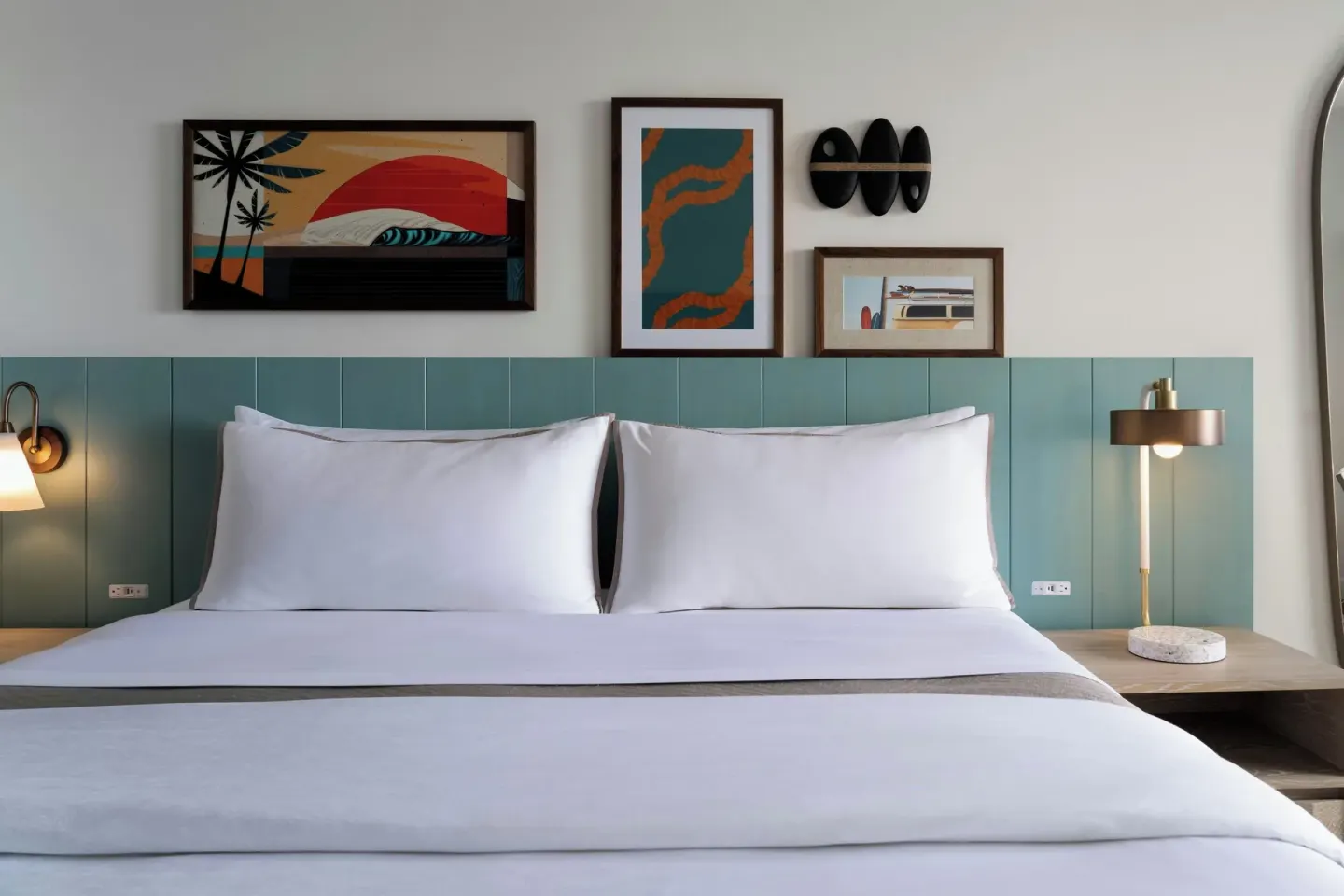 Guest room king bed with teal headboard at Moana Surfrider, A Westin Resort & Spa.