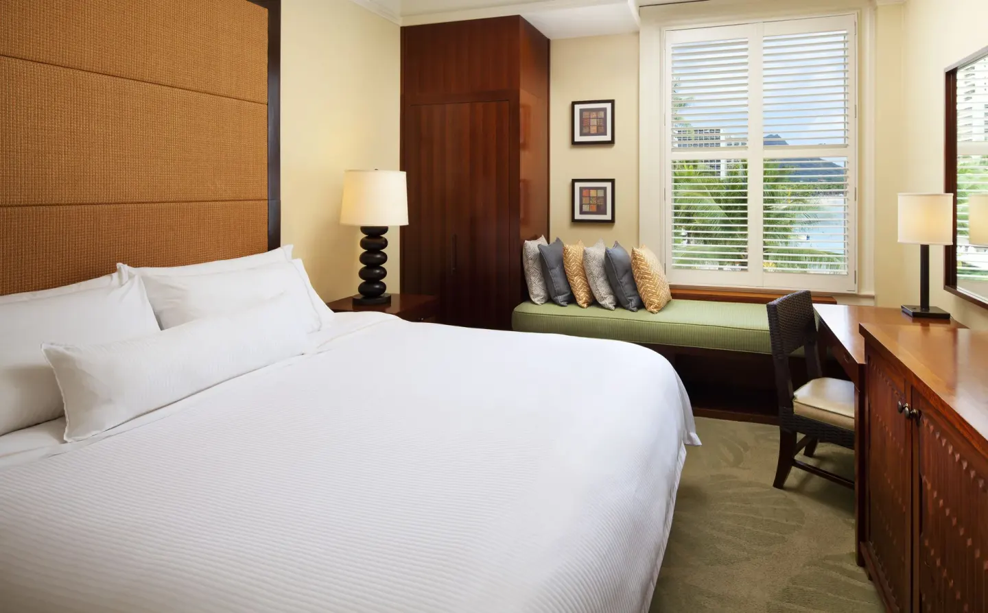 King guest room with shuttered window bench at Moana Surfrider, A Westin Resort & Spa.