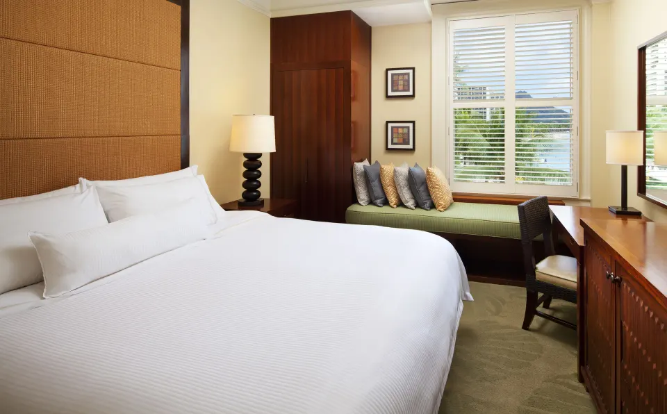 King guest room with shuttered window bench at Moana Surfrider, A Westin Resort & Spa.