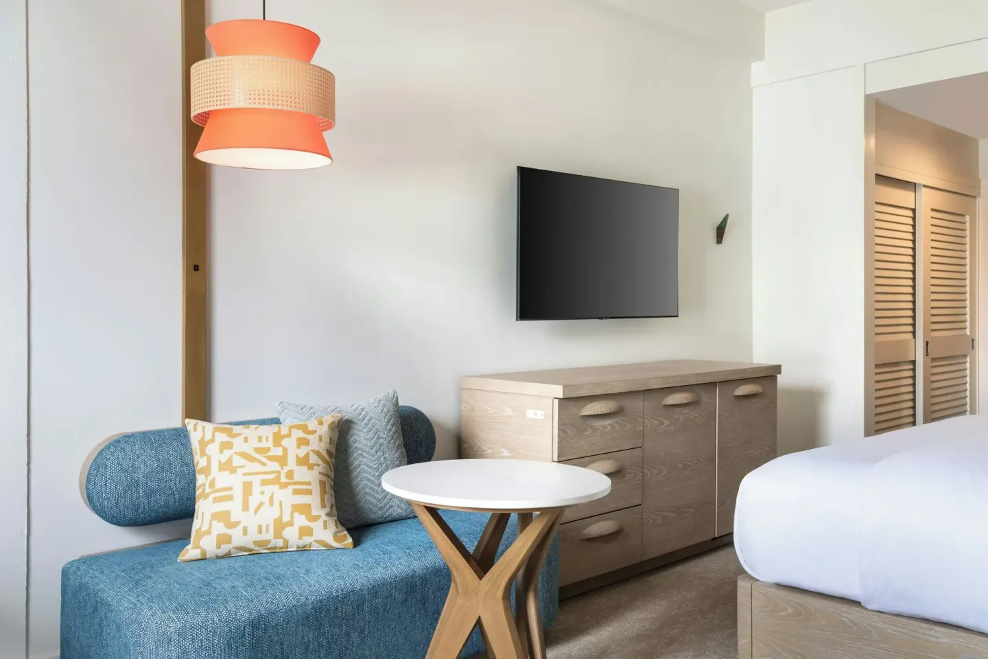 Guest room sitting area and dresser at Moana Surfrider, A Westin Resort & Spa.
