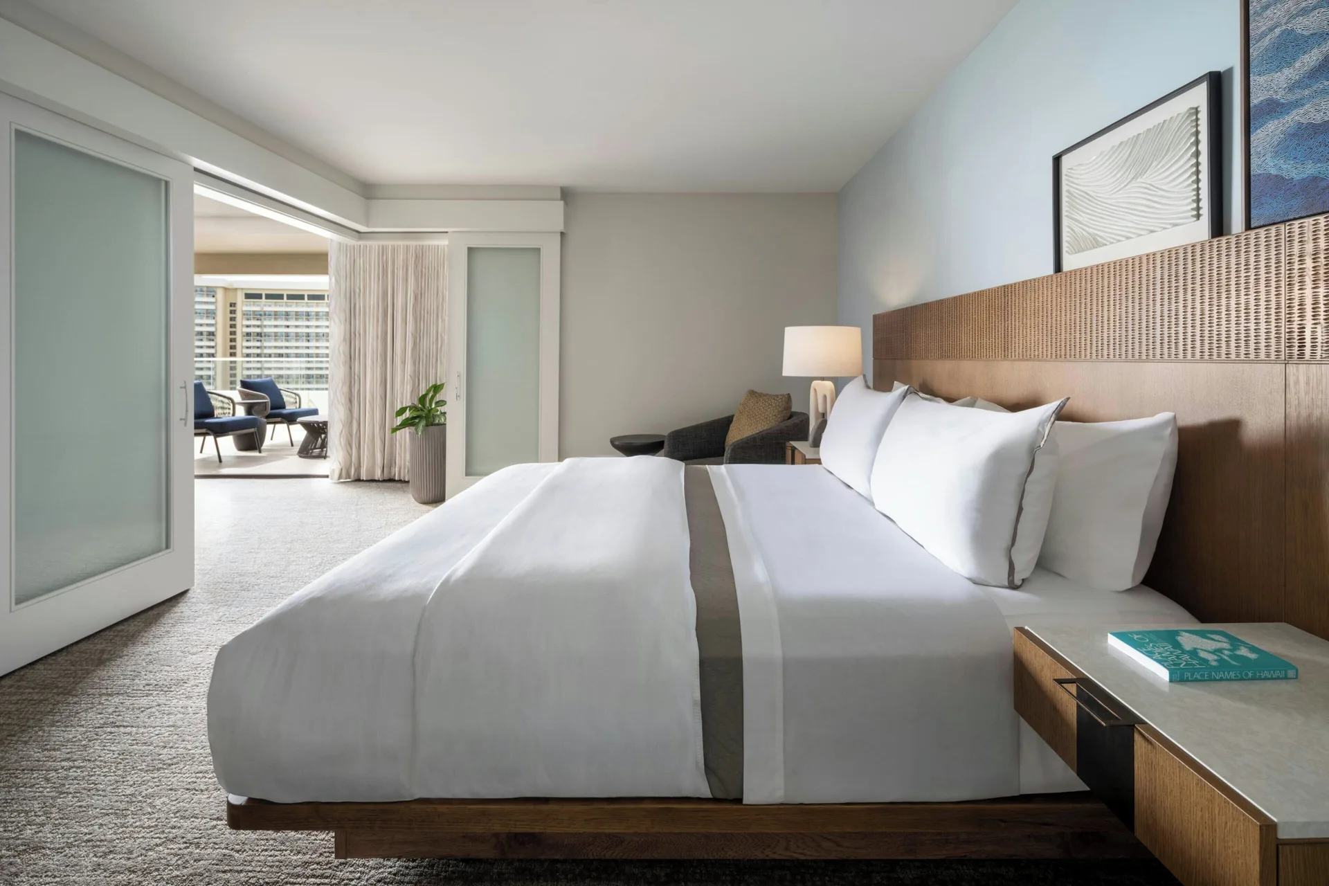 King bedroom with adjoining lounge area at Moana Surfrider, A Westin Resort & Spa.