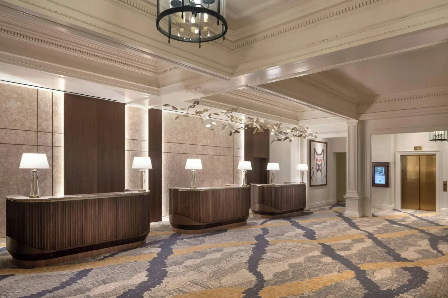 Lobby reception desks and elevator area at Moana Surfrider, A Westin Resort & Spa.
