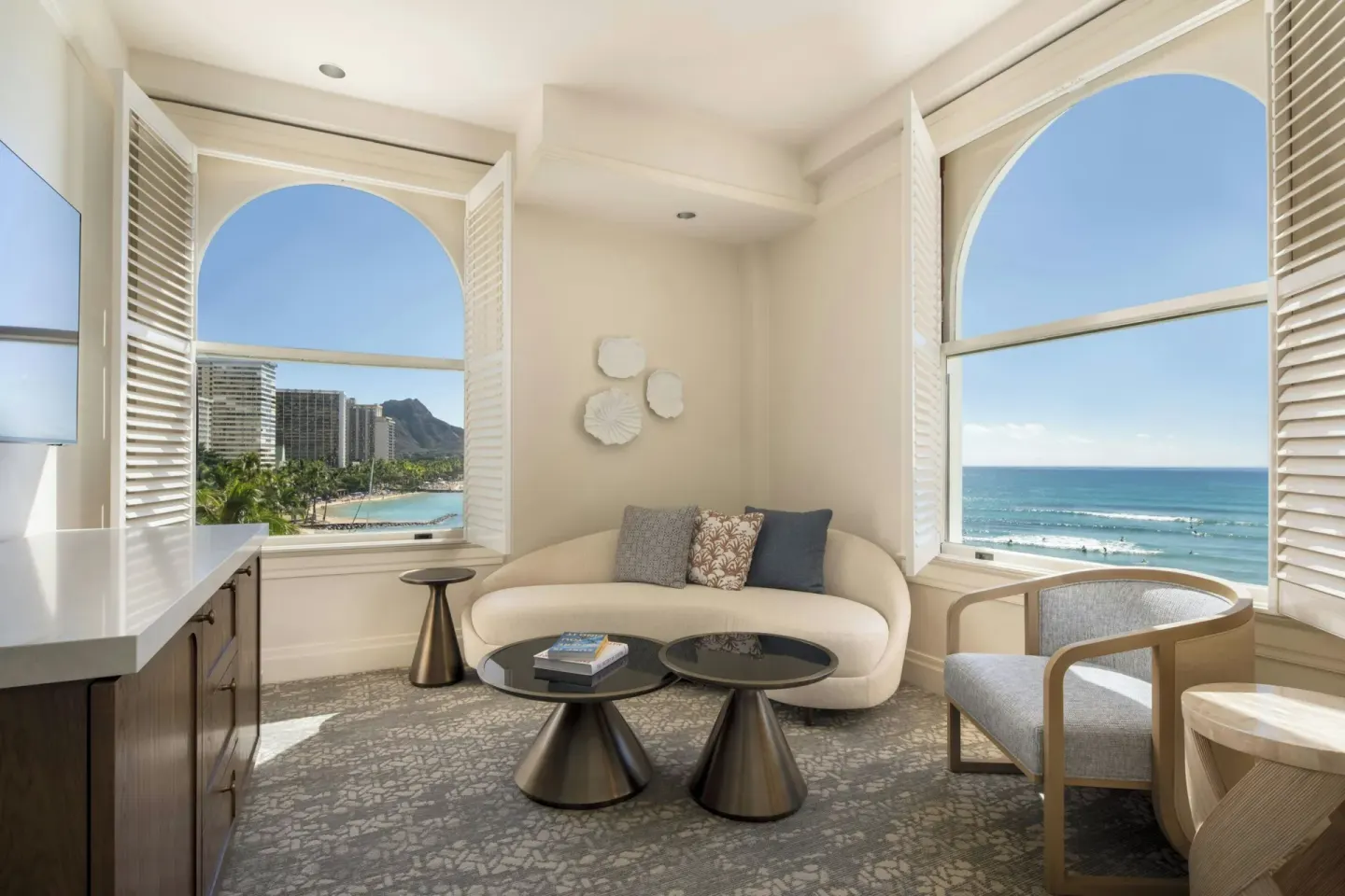 Ocean-view sitting area with arched windows at Moana Surfrider, A Westin Resort & Spa.