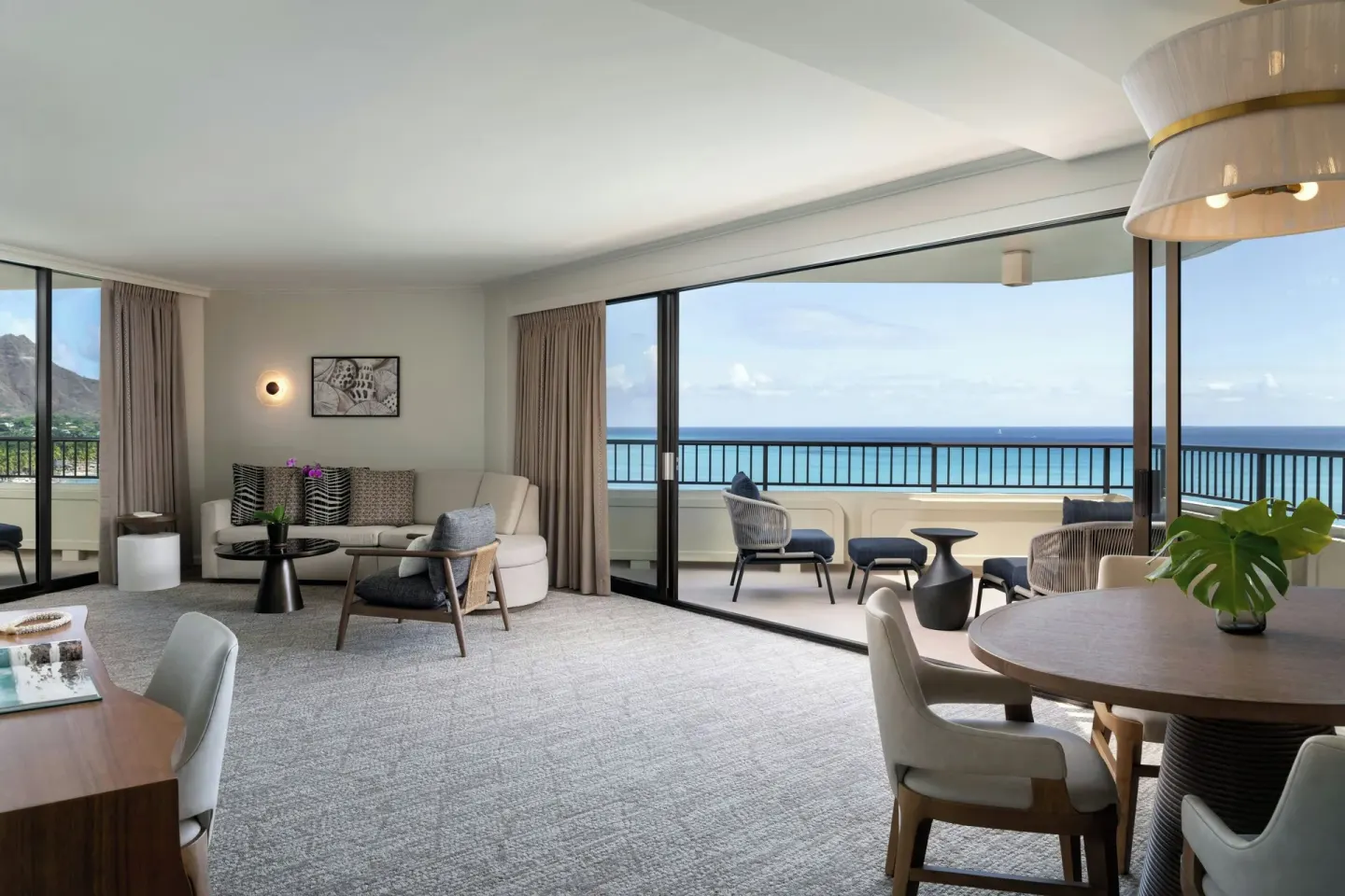Ocean-view suite living and dining area at Moana Surfrider, A Westin Resort & Spa.