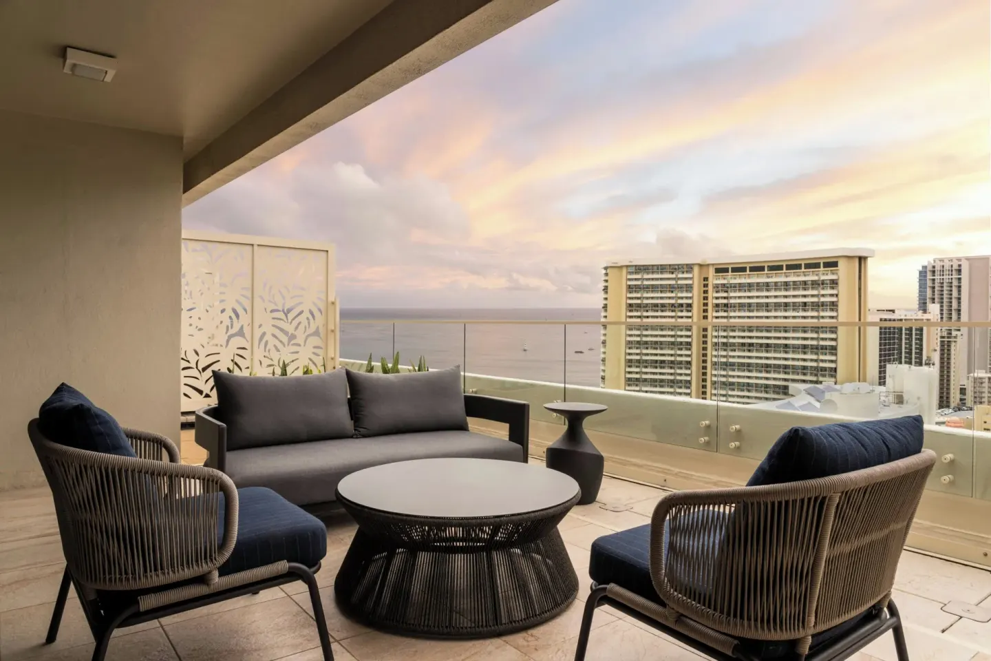 Outdoor terrace seating with ocean and skyline views at Moana Surfrider, A Westin Resort & Spa.