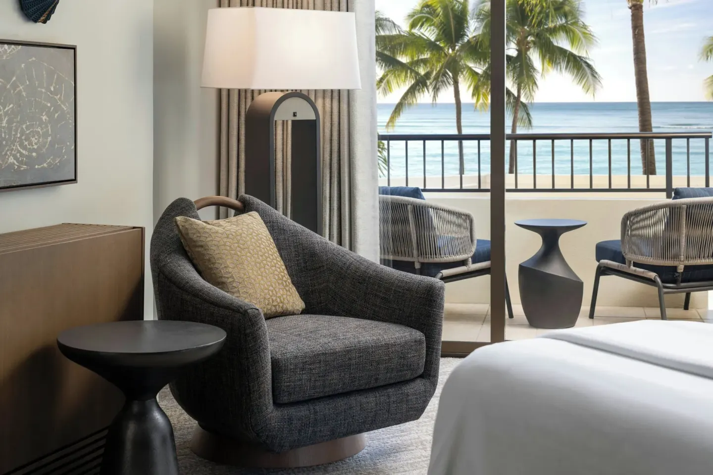 Oceanfront guest room seating and balcony at Moana Surfrider, A Westin Resort & Spa.