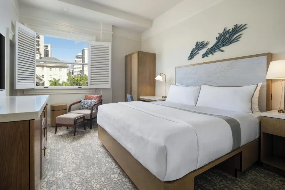 King guest room with shuttered window at Moana Surfrider, A Westin Resort & Spa.