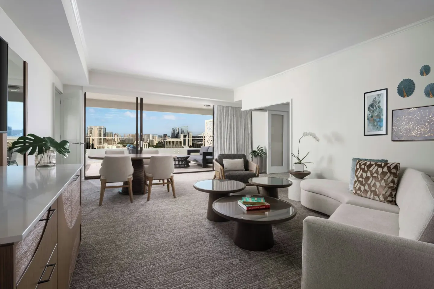 Suite living room with terrace and city view at Moana Surfrider, A Westin Resort & Spa.