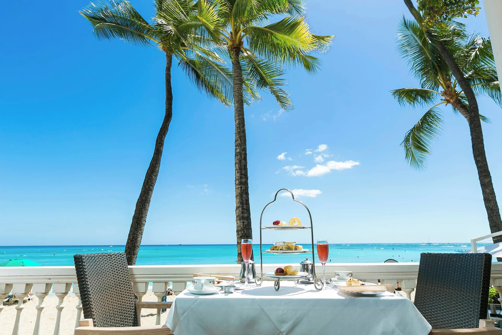 Afternoon tea table overlooks Waikiki Beach at Moana Surfrider, A Westin Resort & Spa.