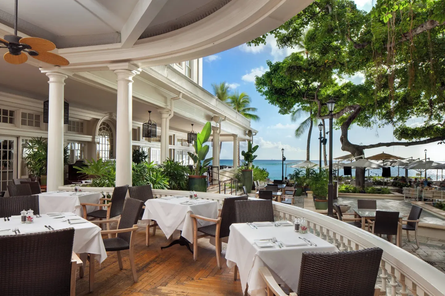 Open-air veranda dining beside the ocean at Moana Surfrider, A Westin Resort & Spa.
