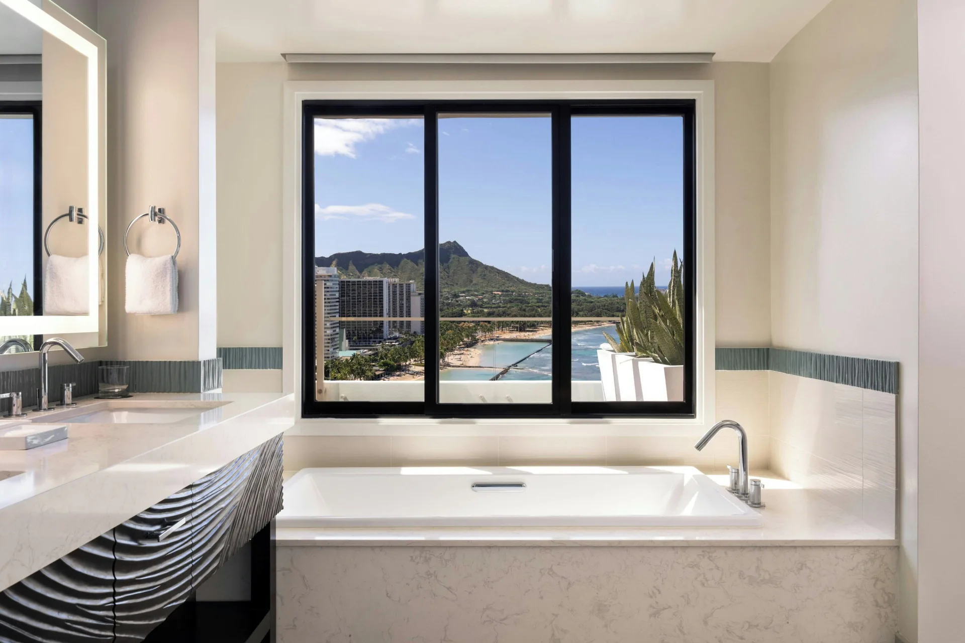 Penthouse Ocean Suite bathroom at Moana Surfrider, A Westin Resort & Spa with soaking tub and Diamond Head view.