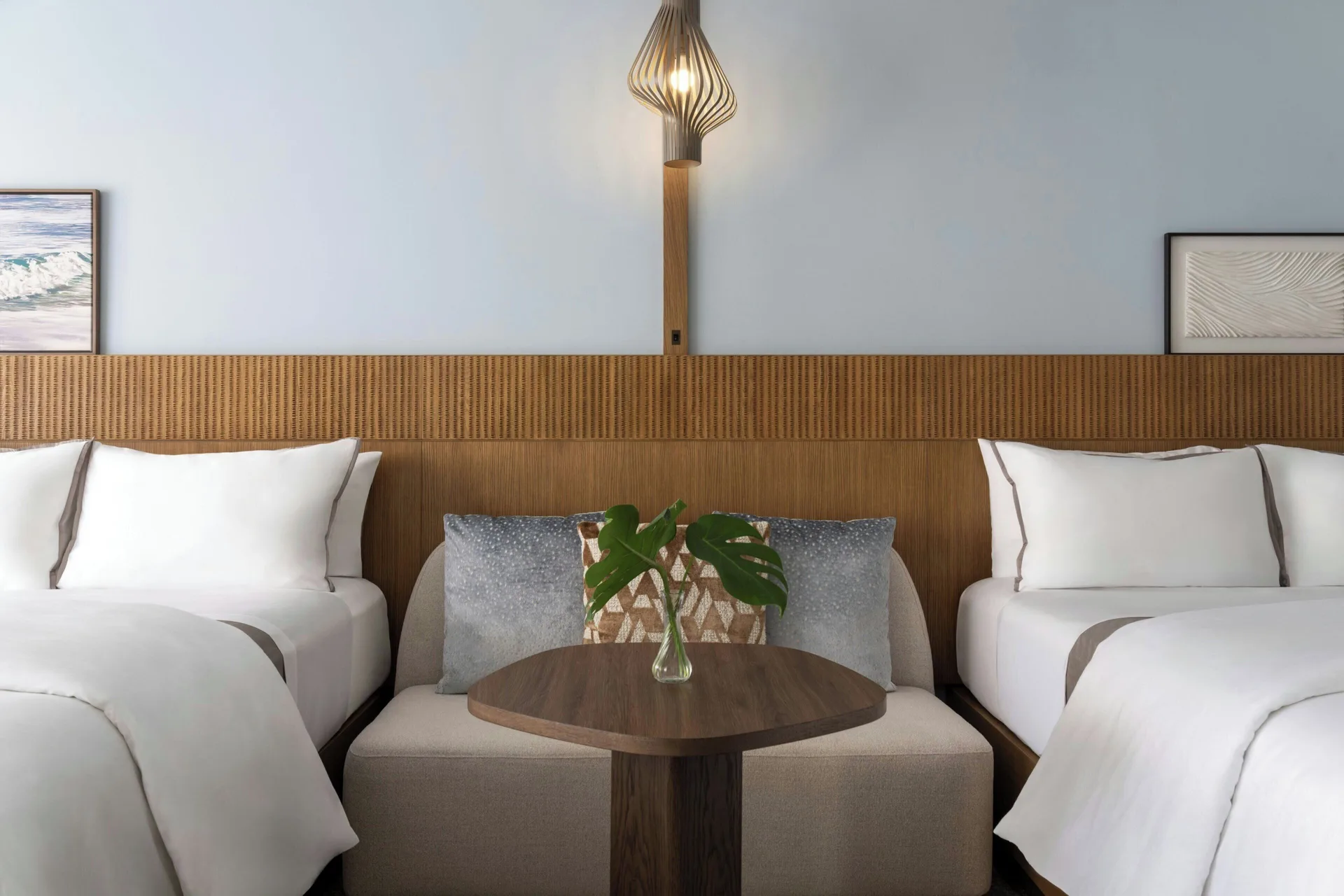 Two beds and a small sitting area in a Tower Penthouse Skyline Room at Moana Surfrider, A Westin Resort & Spa.
