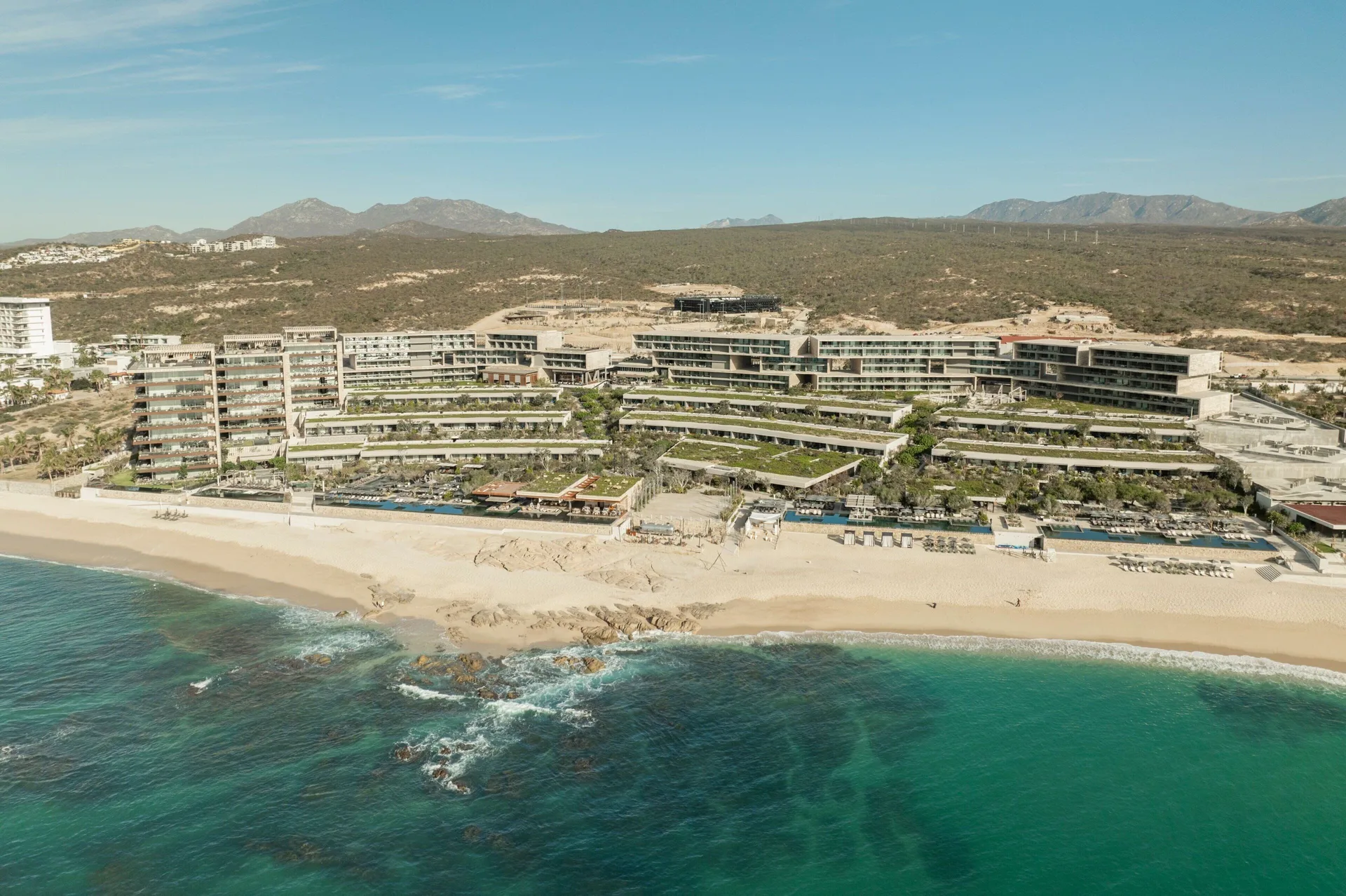 Solaz, A Luxury Collection Resort, Los Cabos with contemporary architecture, infinity pools overlooking the Sea of Cortez, and desert landscaping.