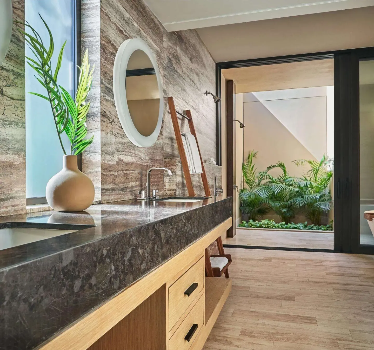 Stone bathroom vanity and garden patio in a guest room at Montage Los Cabos.