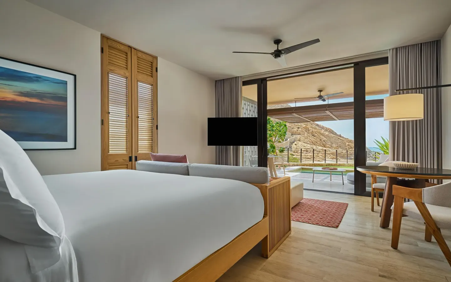 King bed guest room with terrace and hillside view at Montage Los Cabos.