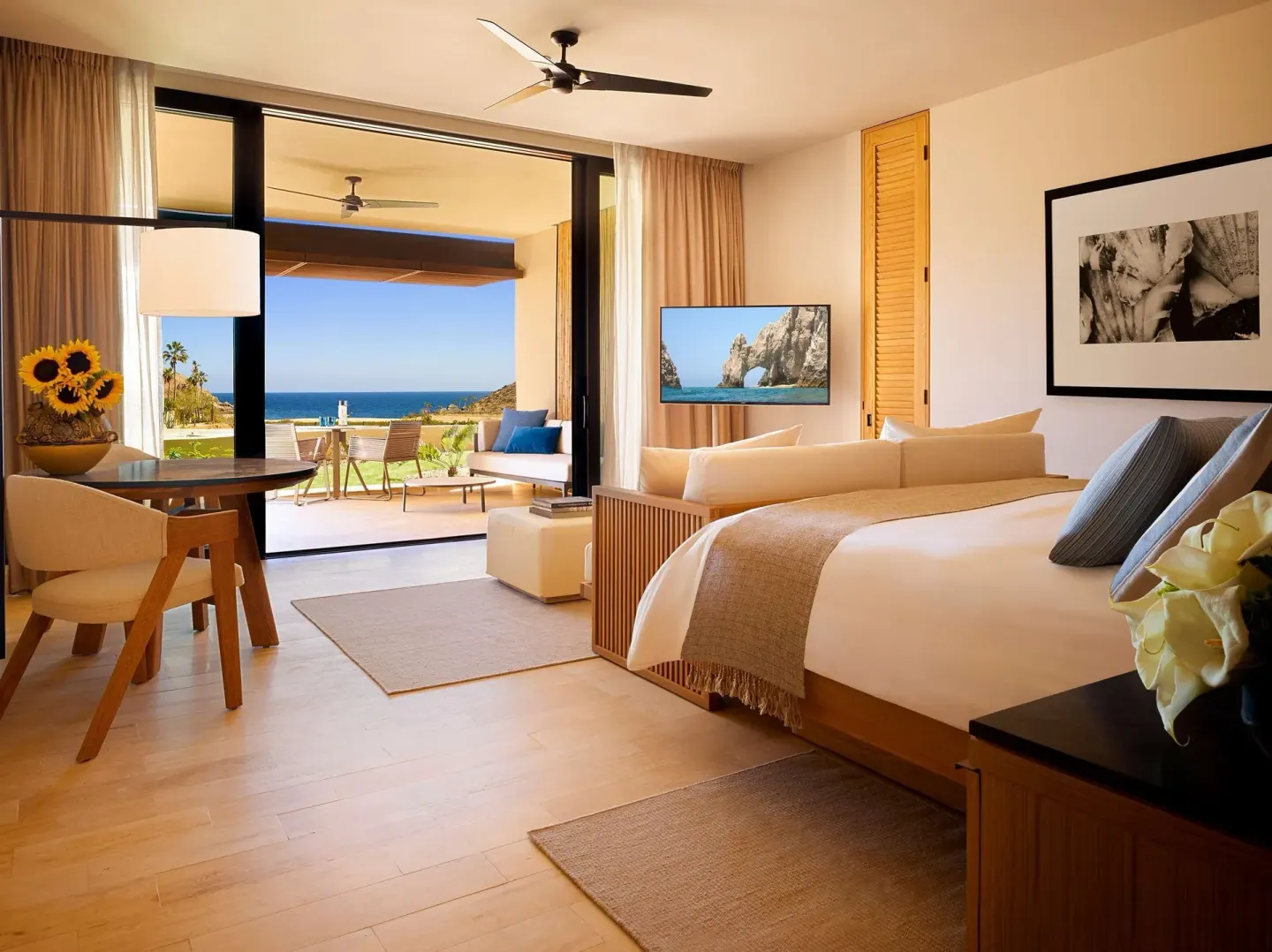 Guest room with king bed, sitting area, and ocean-view balcony at Montage Los Cabos.