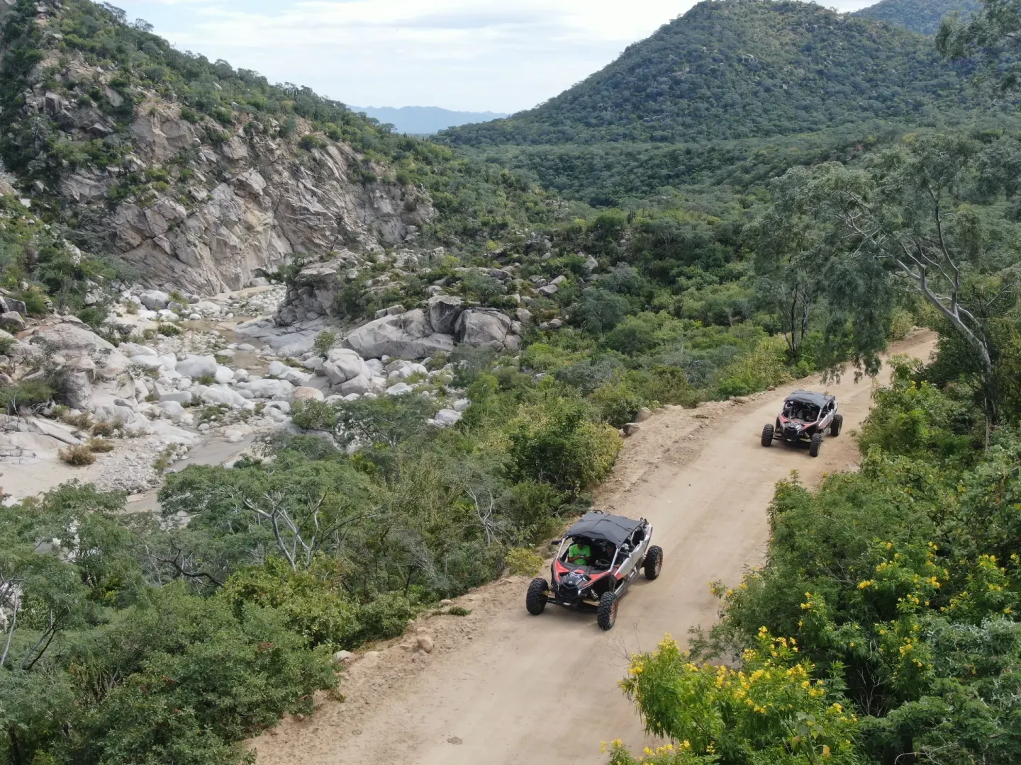 Off-road vehicles travel a canyon dirt road near Montage Los Cabos.