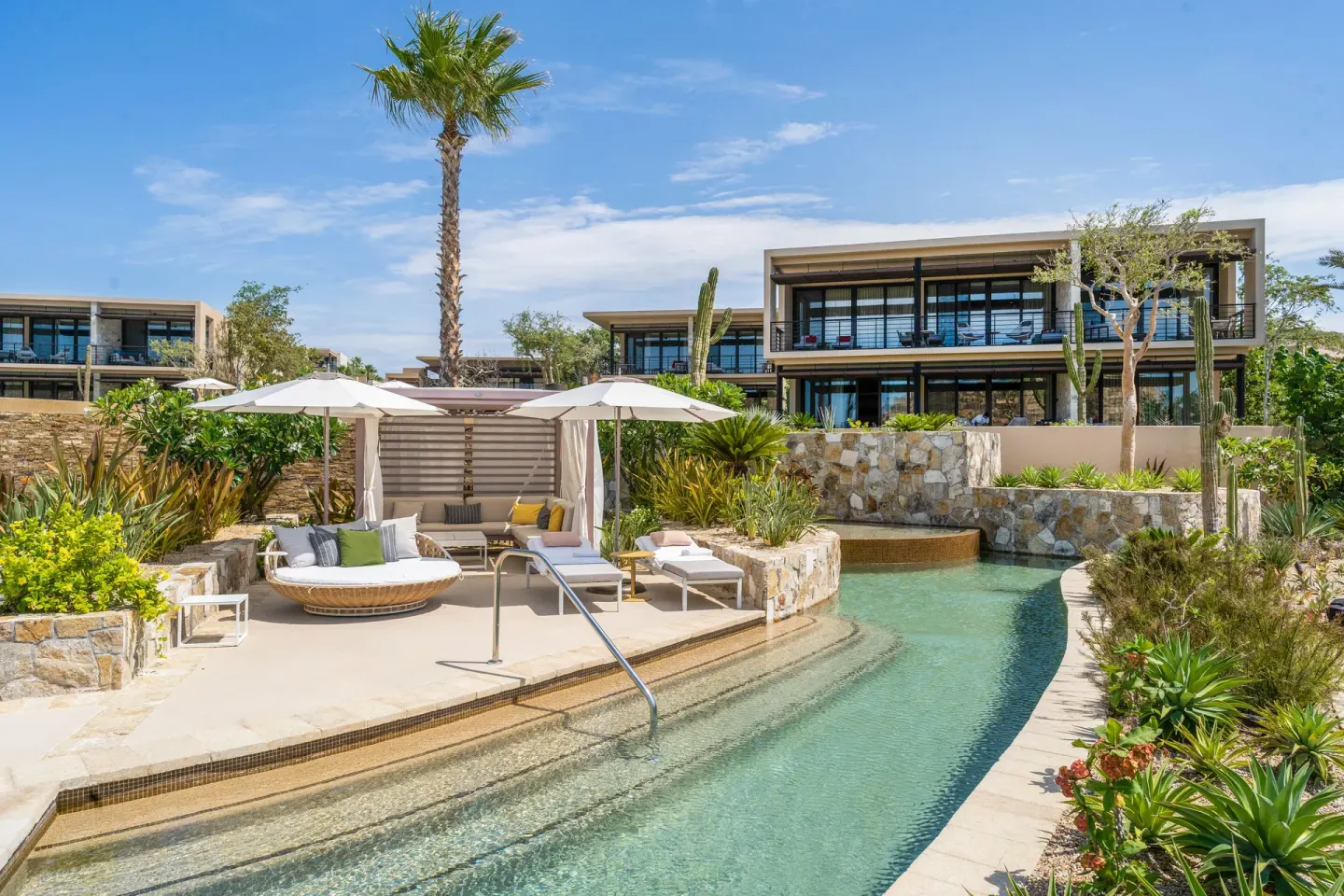 Poolside cabana and lagoon-style waterway among gardens at Montage Los Cabos.