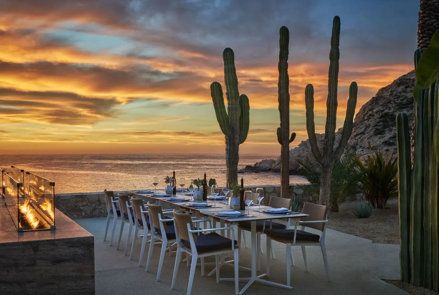 Oceanfront patio dining at sunset with cacti at Montage Los Cabos.