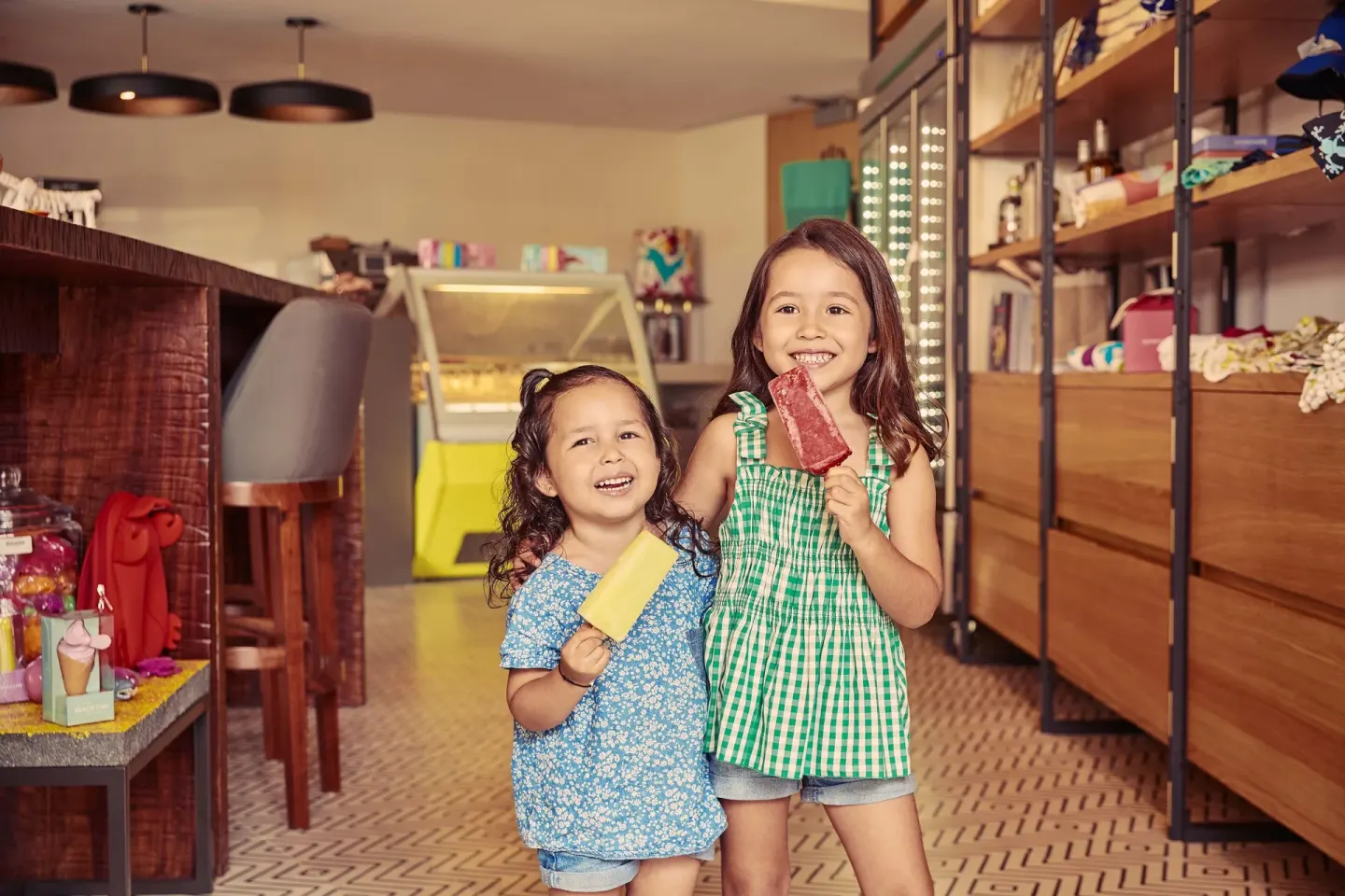 Two children hold frozen paletas inside a cafe shop at Montage Los Cabos.