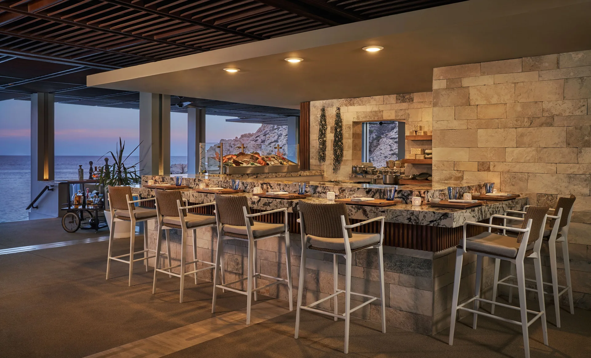 Open-air sushi bar counter with ocean beyond at Montage Los Cabos.