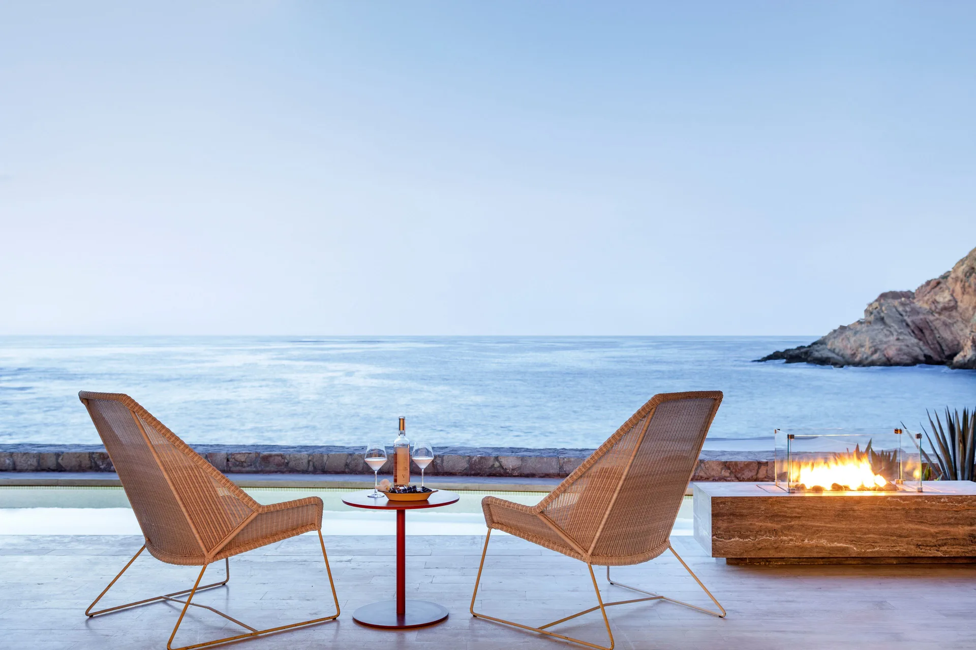 Oceanfront terrace chairs and fire feature at Montage Los Cabos.