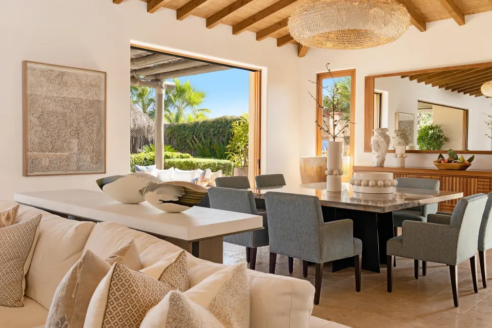 Casa Cardon dining area with sofa and open garden doors at Montage Los Cabos.
