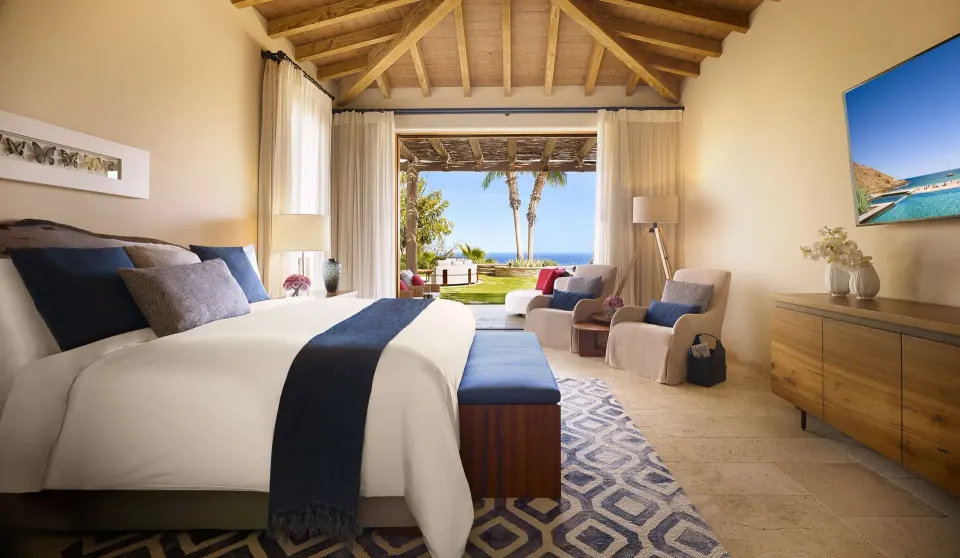 King bedroom in Casa Cardon Five Bedroom Home at Montage Los Cabos opening to a terrace and ocean view.