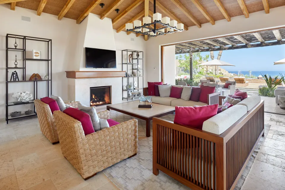 Living room in Casa Cardon Five Bedroom Home at Montage Los Cabos with fireplace and open terrace.