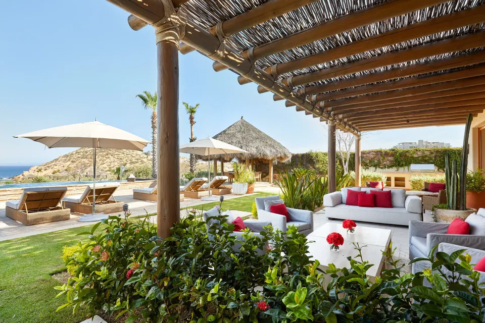 Pergola patio at Casa Cardon Five Bedroom Home at Montage Los Cabos beside loungers and ocean views.