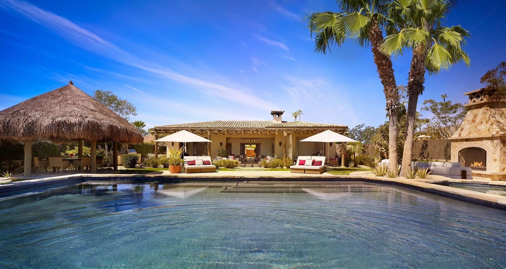 Casa Cardon pool courtyard with palapa, cabanas and outdoor fireplace at Montage Los Cabos.