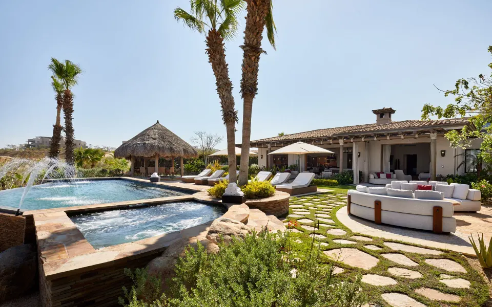 Pool courtyard at Casa Cardon Five Bedroom Home at Montage Los Cabos with loungers and shaded seating.