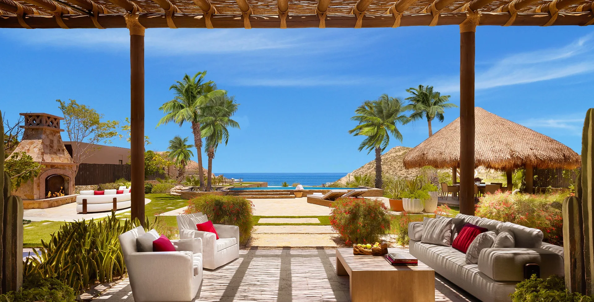Terrace lounge and lawn of Casa Cardon Five Bedroom Home at Montage Los Cabos with ocean beyond.
