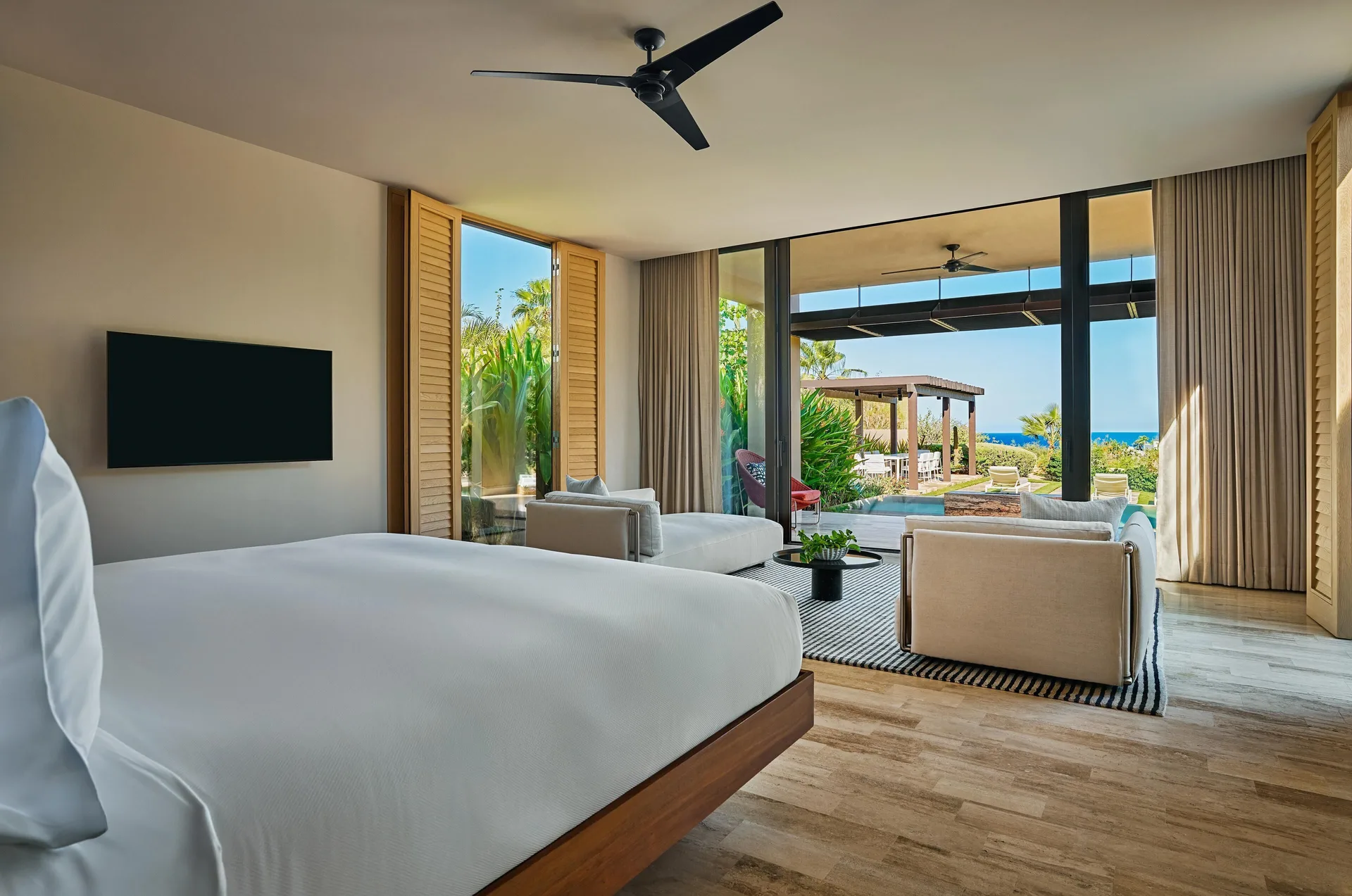 Casa Dolphin bedroom at Montage Los Cabos with king bed, sitting area, terrace, and ocean view.